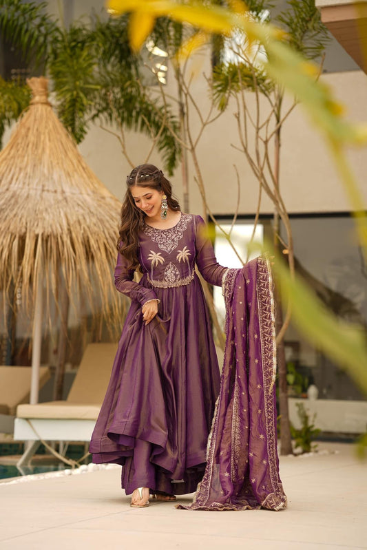 Woman wearing a light purple embroidered Anarkali dress with long sleeves and a matching dupatta