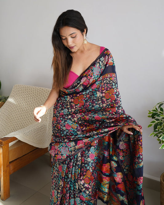 Woman wearing a colorful floral saree in a home setting