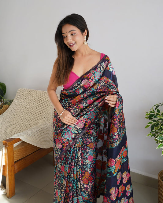 Woman wearing a colorful floral saree in a home setting